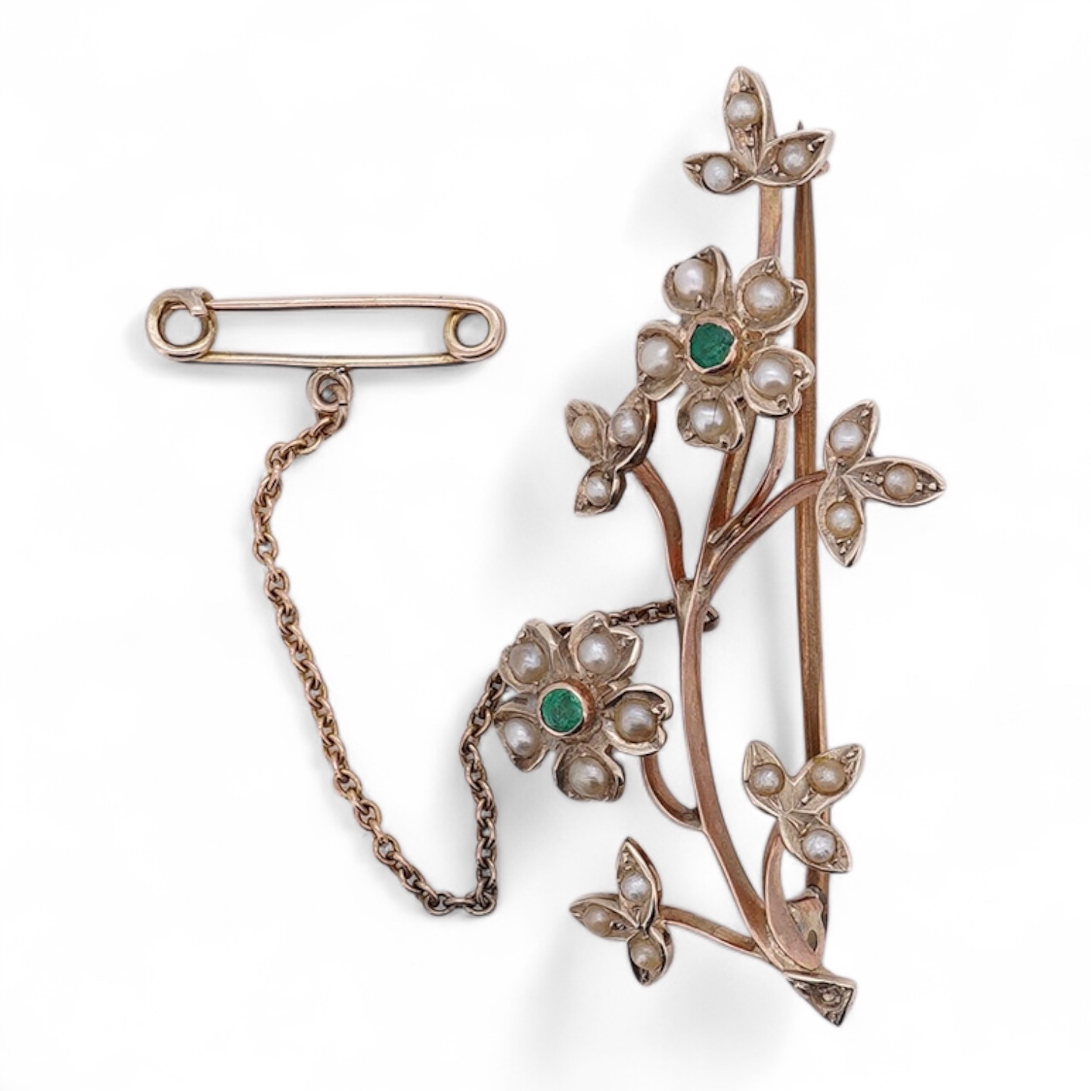 An early 20th century 9ct, seed pearl and emerald cluster set floral spray brooch, 45mm, gross weight 4.4 grams. Condition - poor to fair